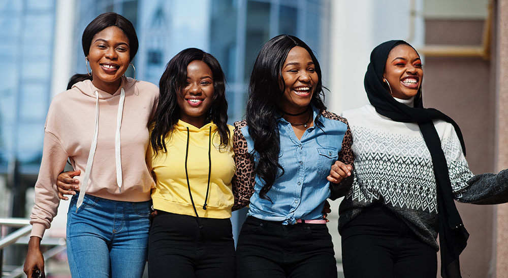Empowered young people - black women, a group of four, one of whom is wearing a headscarf